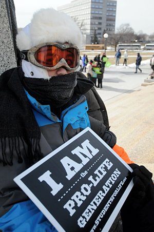 Eligh O'Sullivan, a member of St. Michael in Albertville, waits for the rally to start at the Capitol. (Dianne Towalski/The Catholic Spirit)