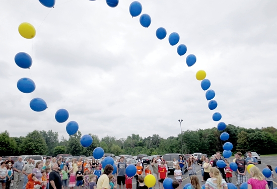 Parishioners at St. Paul in Ham Lake launch a balloon rosary during the annual parish picnic June 22. The launch was in celebration of the 25th anniversary of the Family Formation program, a family catechesis program developed by the parish and sold to other parishes and families throughout the country and beyond. Photo courtesy of Matthew Brounstein
