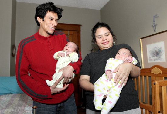From left, Casa Guadalupana residents Elder and Karen hold their newborn twins, Helder, left, and Krystal, who were born on Nov. 8. The couple is from Nicaragua. Dave Hrbacek / The Catholic Spirit