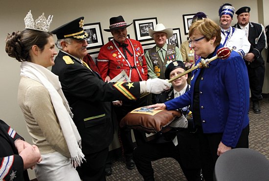 Marilou Eldred, right, president of the Catholic Community Foundation in St. Paul, gets a royal blessing from King Boreas (Steve Cortinas), second from left, during a special ceremony at the foundation headquarters in St. Paul. Members of the Royal Court were on hand to present Eldred with the Spirit of 76 Award. At far left is Ashleigh Hayes, the 2012 Aurora, Queen of the Snows and a graduate of the University of St. Thomas. (Dave Hrbacek/The Catholic Spirit)