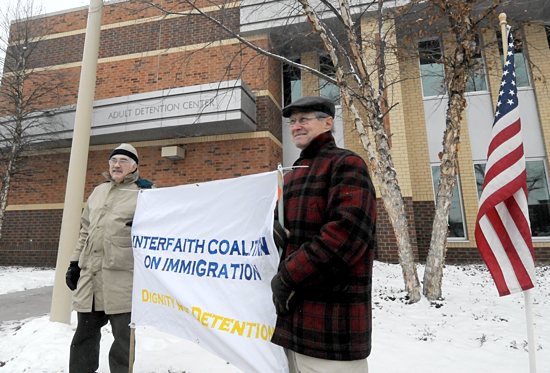 John Joslin, right, a member of St. Stanislaus in St. Paul, and Chris Engen of Holy Trinity Lutheran Church in Minneapolis stand in front of the Ramsey County Adult Detention Center in St. Paul. The two are part of a group that sponsors a prayer vigil in front of the center on the first Sunday of each month. Dianne Towalski / The Catholic Spirit