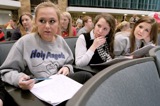 From left, Academy of Holy Angels seniors Annah Blackburn, left, Anne St. Amant and Alyssa Radosevich discuss what they heard during a mock trial Jan. 31 at the University of St. Thomas in St. Paul, in which arguments were made for and against the Roe v.?Wade U.S. Supreme Court decision that legalized abortion in America. Dave Hrbacek / The Catholic Spirit