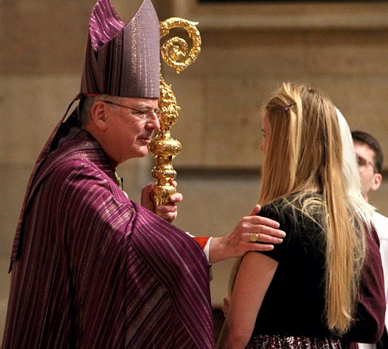 Catechumen Rebecca Rud, who is participating in the Rite of Christian Initiation of Adults at St. Anne in Hamel, greets Archbishop John Nienstedt during The Rite of Election and The Call to Continuing Conversion at the Cathedral of St. Paul Feb. 17. Rud and other catechumens and candidates from throughout the Archdiocese of St. Paul and Minneapolis came to the Cathedral. A similar ceremony was held at the Basilica of St. Mary in Minneapolis. (Dave Hrbacek/The Catholic Spirit)