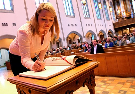Catechumen Heather Kasel signs the Book of the Elect at Nativity of Our Lord in St. Paul Feb. 17. Kasel went to The Rite of Election and The Call to Continuing Conversion at the Cathedral of St. Paul that afternoon. As of Feb. 12, 214 catechumens and 473 candidates were preparing for initiation. (Dave Hrbacek/The Catholic Spirit)