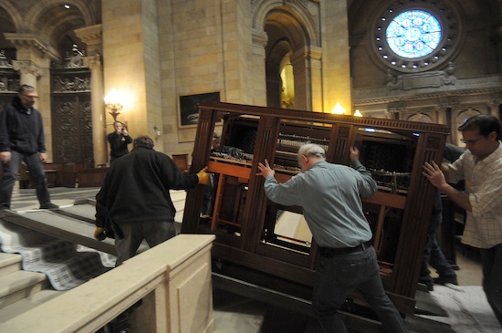 One of the two new organ consoles is moved into the Cathedral sanctuary Feb. 28