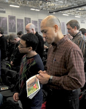Leo Avenido and his son Ryan, 14, members of St. Joseph in Rosemount prayed during the conference, which was  sponsored by the archdiocesan Office of Marriage, Family and Life.