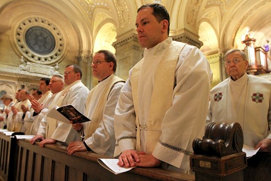 Father Robert Pish of the St. Paul Seminary School of Divinity joins with other priests in the Renewal of Commitment to Priestly Service during the Chrism Mass.