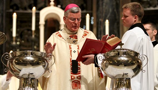 Archbishop John Nienstedt prays during the blessing of the oil of catechumens and consecration of chrism near the end of the Chrism Mass at the Cathedral of St. Paul March 19. Chrism is a fragranced oil that only a bishop can consecrate. It is used during baptisms, confirmations and the ordination of priests and bishops as well as during the dedication and consecration of churches and altars. The oil of catechumens is used for infant baptisms and in some of the preparatory rites for ­catechumens as they prepare for baptism and initiation into the Catholic Church. Also blessed during the Mass is the oil of the sick, which is used in the sacrament of the anointing of the sick. Each parish in the archdiocese receive the holy oils to use in the coming year.