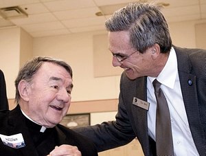 Msgr. Jerome Boxleitner, left, talks with Catholic Charities CEO Tim Marx at the Dorothy Day Center Community Breakfast last May in St. Paul. (Photo courtesy of Catholic Charities)