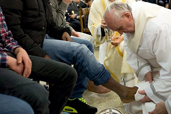 Pope Francis washes the foot of a prison inmate during the Holy Thursday Mass of the Lord's Supper at Rome's Casal del Marmo prison for minors March 28. Pope Francis washed the feet of 12 young people of different nationalities and faiths, including at least two Muslims and two women, who are housed at the juvenile detention facility.