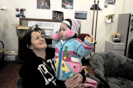 Imelda and her daughter Elena Joana, 1, sit in the Ecuadorian Consulate office in Minneapolis. The area behind them will be remodeled to house Centro Vida y Salud, a health resource center run in cooperation with St. Mary’s Health Clinics. Dianne Towalski / The Catholic Spirit