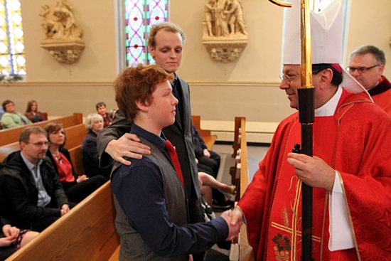 Matthew Brown greets Bishop Lee Piché after being confirmed during a special Mass April 22 at St. Mary in Stillwater. His scheduled confirmation was moved up to accommodate the failing health of his sponsor, Zach Sobiech, center, who was diagnosed with osteosarcoma, a rare form of bone cancer, in November 2009. The disease has advanced and spread to the point that he is not expected to overcome the tumors that now fill his body. Watch TheCatholicSpirit.com for an upcoming story about the journey of faith and courage for Zach and his family. Dave Hrbacek / The Catholic Spirit