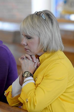 Sharon Balk, a member of St. Paul in Ham Lake prays during the Mass with Archbishop Nienstedt.