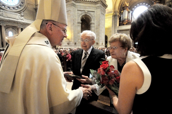 Archbishop John Nienstedt and Jean Stolpestad, right, director of the Archdiocesan Office of Marriage, Family and Life, presented a plaque and flowers to Ambrose and Leona Yantes, members of St. Peter in Delano, who celebrated their 75th anniversary this year.