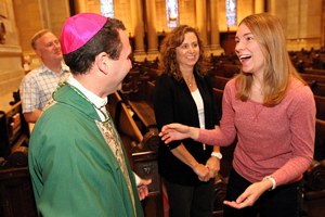 Bernadette Shaffer, right, who works with middle school faith formation at Epiphany in Coon Rapids, greets Bishop-elect Andrew Cozzens after Mass at the Cathedral. At center is Bishop-elect Cozzens’ sister, Helen Healy. (Dave Hrbacek/The Catholic Spirit)