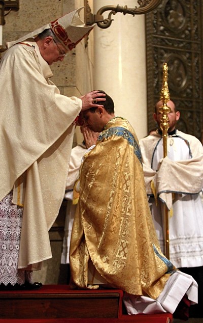 Archbishop Nienstedt lays hands on Bishop Cozzens.