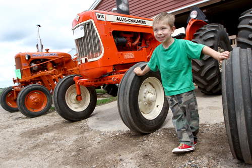 Isaac Marquette of St. Mary in Waverly checks out some vintage tractors. Dave Hrbacek/The Catholic Spirit