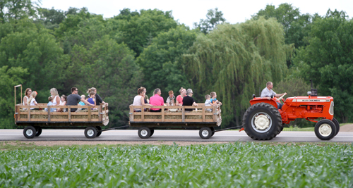 Dan Rosckes, son of Vernon and Elaine Rosckes, takes folks on a tractor ride. Dave Hrbacek/The Catholic Spirit