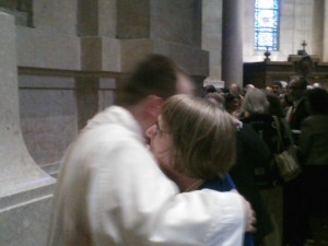 Father John Powers and his mother, Marge, hug after the son gave his mother his first blessing as a priest.