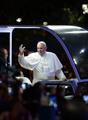 Pope Francis waves as he rides in his popemobile down Benjamin Franklin Parkway to the Festival of Families during the World Meeting of Families in Philadelphia Sept. 26. CNS photo/Jewel Samad, pool