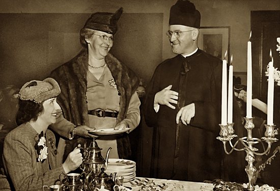 In this photo of Cathedral parish activities dated May 18, 1947, Mrs. John F. Fallon, left, pours tea with Mrs. John Varstraete, one of the first brides to be married in the Cathedral (1916), and Msgr. George Ryan, rector of the Cathedral, at an open house. Courtesy Cathedral of St. Paul