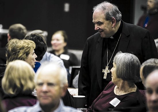 Archbishop Bernard Hebda gives his attention to a listening session participant Nov. 4 at the University of St. Thomas in St. Paul. Eric Wuebben/For The Catholic Spirit
