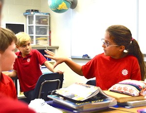 Classmates give their attention to Maggie Kramer in their fourth-grade class at St. Michael School. Bob Zyskowski/The Catholic Spirit
