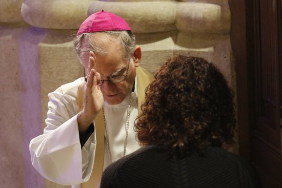Auxiliary Bishop Peter J. Byrne of New York blesses a woman after hearing her confession Dec. 9 at St. Patrick's Cathedral in New York City. The Archdiocese of St. Paul and Minneapolis will hold 24 hours of confessions March 4-5 at the Cathedral of St. Paul and Basilica of St. Mary. CNS