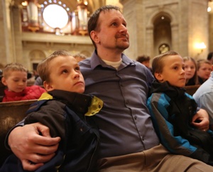 Joe Vandermark, center, of Our Lady of the Prairie in Belle Plaine sits with his twin sons, Alex, left, and Zach at the annual Prayer Service for Life at the Cathedral of St. Paul in St. Paul Jan. 22. Dave Hrbacek/The Catholic Spirit