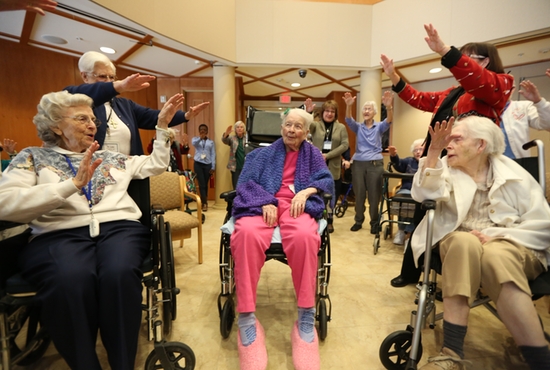 Sister Mary Mark Mahoney, center, receives a blessing in the chapel of Carondelet Village in St. Paul during a surprise party to celebrate her 105th birthday Jan. 11. She is a retired St. Joseph Sister of Carondelet who lives at Carondelet Village. Dave Hrbacek/The Catholic Spirit