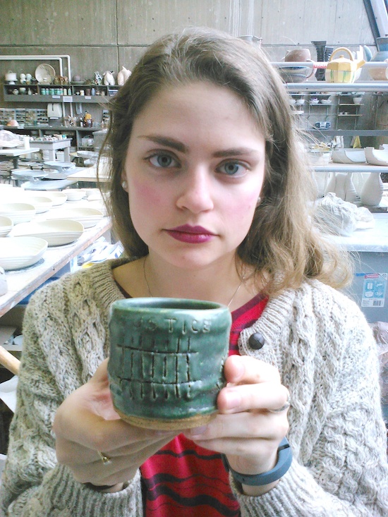 Lizzie Cleary holds one of the tea cups that will be part of an art installation at first the St. Paul campus and then the Minneapolis campus of St. Catherine University. The cup was made by Cleary, a studio art major, but it was decorated by someone with personal experience of domestic violence. Bob Zyskowski/The Catholic Spirit