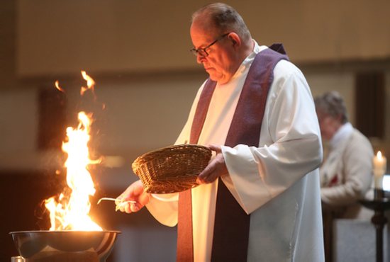 Father Thomas Kommers burns palms during an Ash Wednesday prayer service at St. Joseph in Red Wing. Dave Hrbacek/The Catholic Spirit