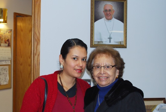 Mayra Mendez and Geraldine Lopez pose with a picture of Pope Francis in the vestibule of Our Lady of Guadalupe in St. Paul after Mass Feb. 14. Courtesy Juan Gutierrez