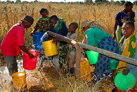 Tanzanian children collect running water from a well made possible through the Tanzania Life Project. The image has become an icon for Jim and Katie Vanderheyden, the organization’s founders. John Boyer/Courtesy Tanzania Life Project