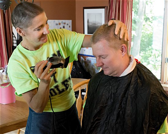 After getting her hair cut by family members, Kristen Soley cuts her husband Nathan’s hair. Courtesy Tina Fisher Photography 
