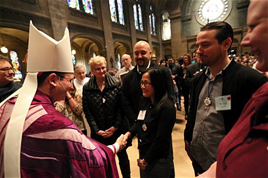 Rafiann Olchefske, right, greets Bishop Andrew Cozzens during the Rite of Election Feb. 14 at the Basilica of St. Mary in Minneapolis. Dave Hrbacek/The Catholic Spirit