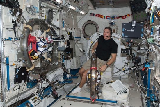 Astronaut Mike Hopkins works with a pair of free-flying satellites in the International Space Station's Kibo laboratory Nov. 4, 2013. Hopkins was able to observe his Catholic faith through prayer and taking holy Communion throughout his flight. CNS photo/courtesy NASA