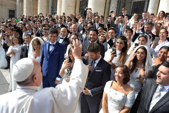 A newly married couple arrive in St. Peter's Square to attend Pope Francis' general audience at the Vatican in this Oct. 14, 2015, file photo. CNS photo/Paul Haring