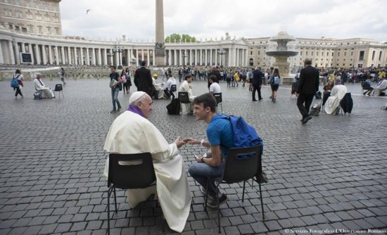 Pope Francis hears confession of a youth April 23 in St. Peter's Square at the Vatican. CNS photo/L'Osservatore Romano via Reuters