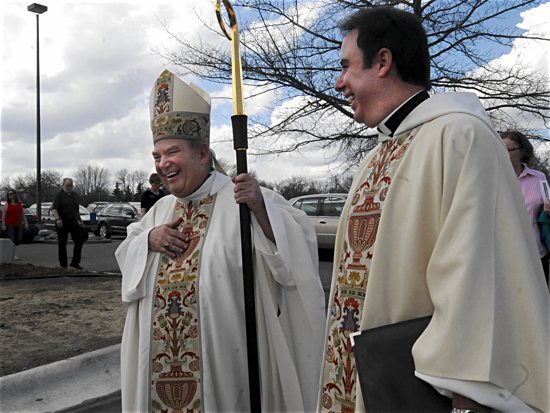 Archbishop Bernard Hebda and Father Rick Banker, pastor of St. Rita in Cottage Grove, share a laugh following an April 17 Mass celebrating the parish’s 50th anniversary. Dianne Towalski/For The Catholic Spirit