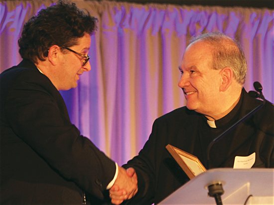 Archbishop Bernard Hebda greets Steve Hunegs, executive director of the Jewish Community Relations Council of Minnesota and the Dakotas, during a Dec. 2, 2015, event in Minneapolis commemorating the 50th anniversary of the Vatican II document “Nostra Aetate.” Dave Hrbacek/The Catholic Spirit 