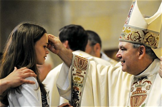 Archbishop Bernard Hebda confirms a youth April 17 at the Cathedral of St. Paul in St. Paul. Dianne Towalski/For The Catholic Spirit