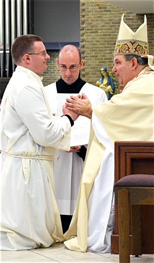Bishop Bernard Hebda of Gaylord, Michigan, ordains Father Brian Medlin a transitional deacon in 2012 (above) and a priest in 2013. Courtesy the Diocese of Gaylord. 