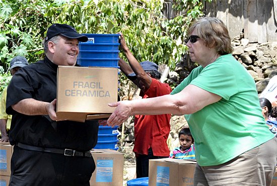 As part of a sister-diocese project of the Diocese of Gaylord, then-Bishop Hebda helps deliver water filters to families in a remote area of the Diocese of Matagalpa, Nicaragua. Courtesy the Diocese of Gaylord