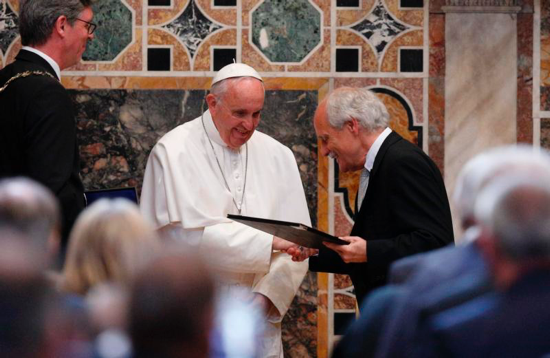 Pope Francis receives the Charlemagne Prize from Jurgen Linden, president of the Society for the Conferral of the Charlemagne Prize, during a ceremony in the Sala Regia at the Vatican May 6. At left is Marcel Philipp, mayor of Aachen, Germany, where the prize is normally presented. CNS photo/Paul Haring