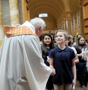 Caroline Miltich from St. Andrew School in Elk River, Minn., and other students are greeted by Bishop Donald J. Kettler of St. Cloud, Minn., after a May 9 prayer service in the Sacred Heart Chapel at St. Benedict's Monastery in St Joseph, Minn. About 350 students from 17 schools participated in the pilgrimage. CNS photo/Dianne Towalski, The Visitor