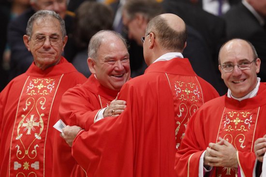 Archbishop Bernard Hebda of St. Paul and Minneapolis, center, exchanges the sign of peace with Archbishop Darci Jose Nicioli of Diamantina, Brazil, as Pope Francis celebrates Mass with new archbishops from around the world in St. Peter's Basilica at the Vatican June 29. Archbishop Hebda was among 25 new archbishops invited to the Mass, which marked the feast of Sts. Peter and Paul. At left is Archbishop Juan Garcia Rodriguez of Havana and at right Archbishop Felice Accrocca of Benevento, Italy. CNS