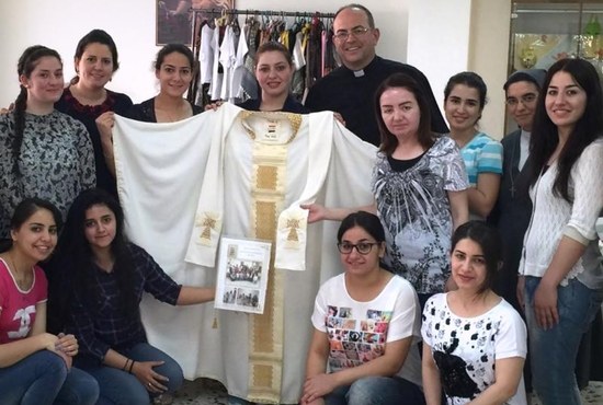 Iraqi refugee women who fled Islamic State group violence in their homeland pose for a photo in Amman, Jordan, in early June. The Chaldean Catholic women sent the hand-sewn chasuble to Pope Francis and asked him to pray for them and for peace in their country. CNS photo/courtesy Catholic Center for Studies and Media in Amman