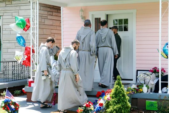 Franciscan Friars of the Renewal from New York pay their respects at the childhood home of boxing legend Muhammad Ali June 5 in Louisville, Ky. Ali died June 3 at age 74 after a long battle with Parkinson's disease. CNS photo/John Sommers II, Reuters)