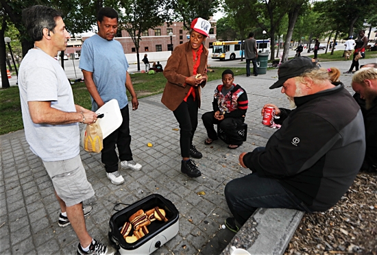 Engelmann offers free hotdogs June 15 to homeless people gathered in downtown St. Paul. Dave Hrbacek/ The Catholic Spirit